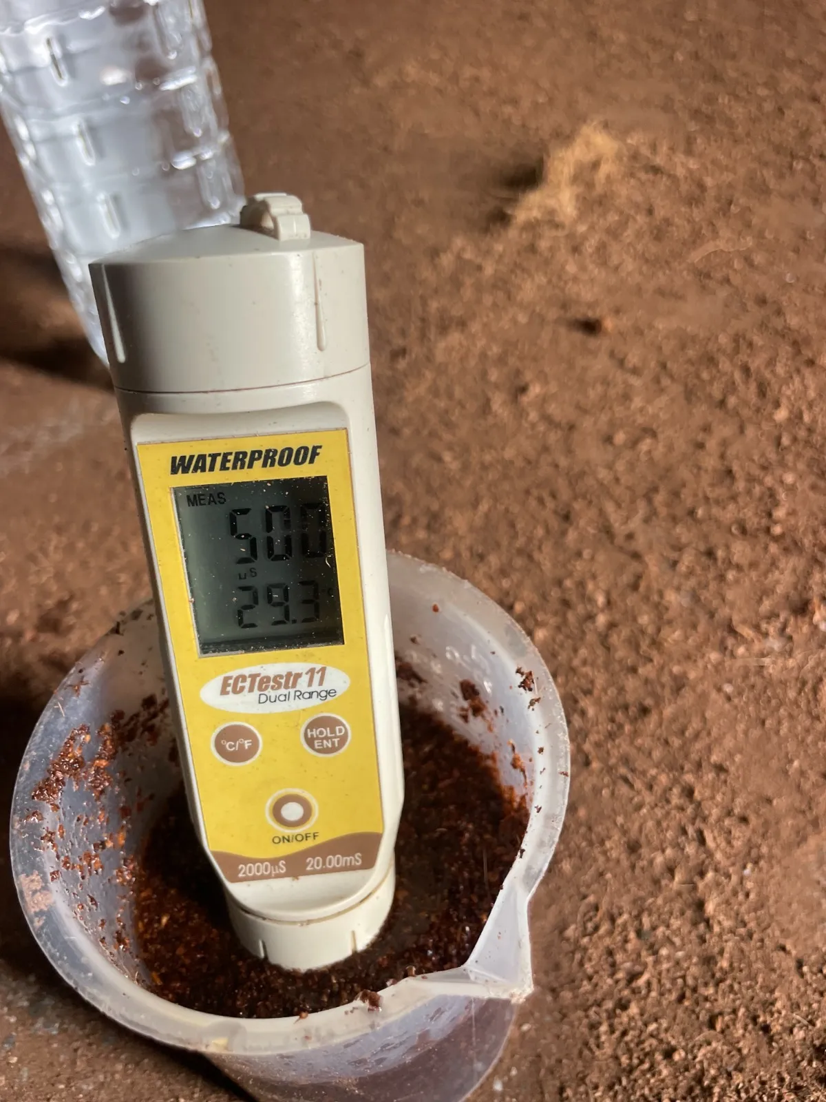 Checking the EC of coir pith with a meter